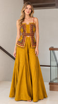 Front full view of mustard yellow embroidered peplum cami top and palazzo pants set