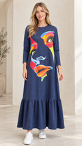 Front view of woman wearing Navy Blue abstract graphic print tiered maxi dress with white sneakers