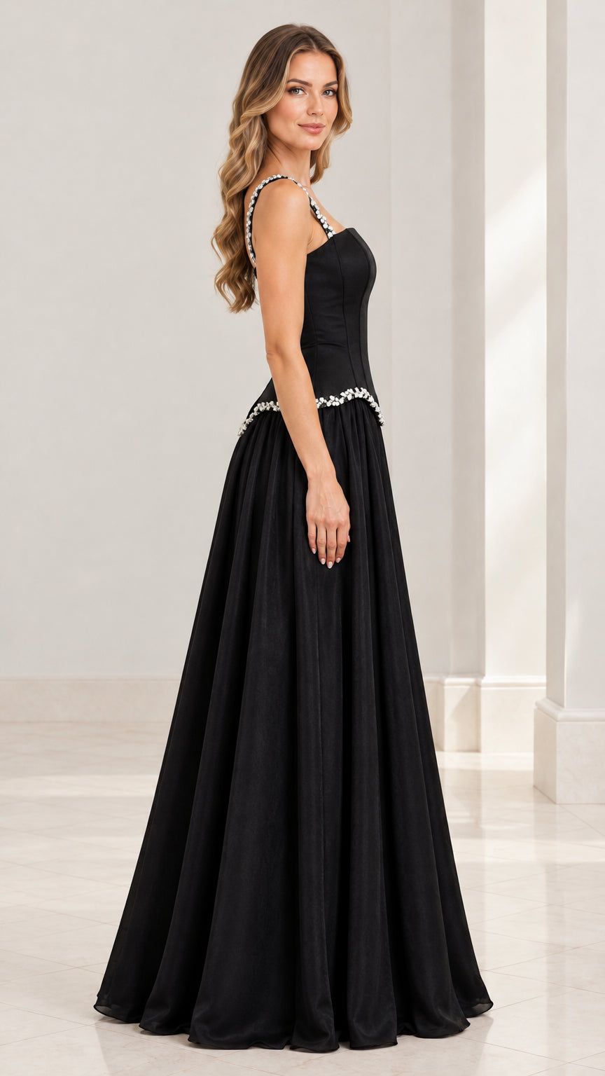Side profile view of the floor-length black evening dress with crystal straps