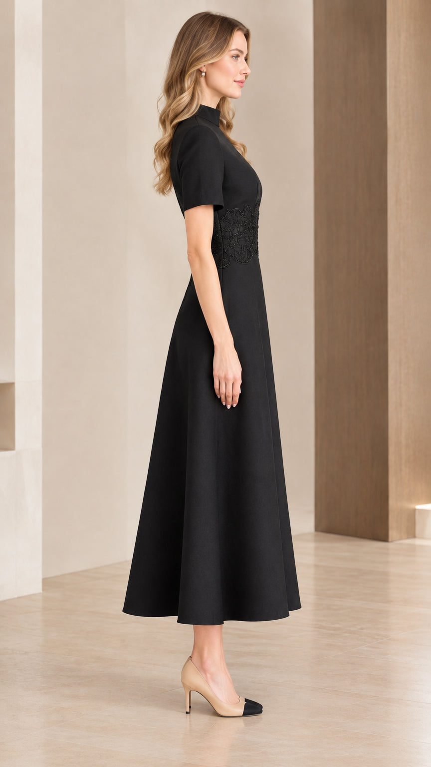 Side profile of woman wearing black short sleeve fit and flare midi dress