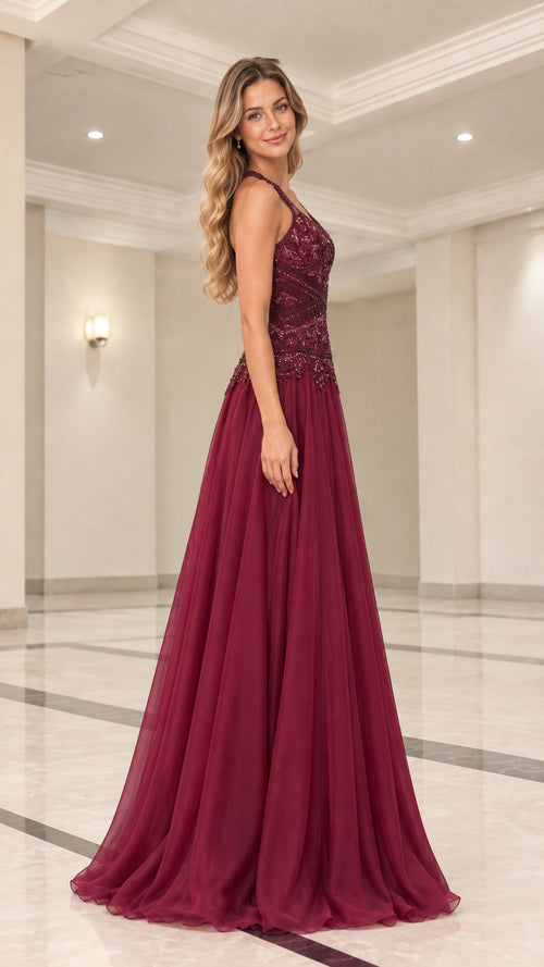 Side profile of model wearing floor-length burgundy formal dress with beaded bodice