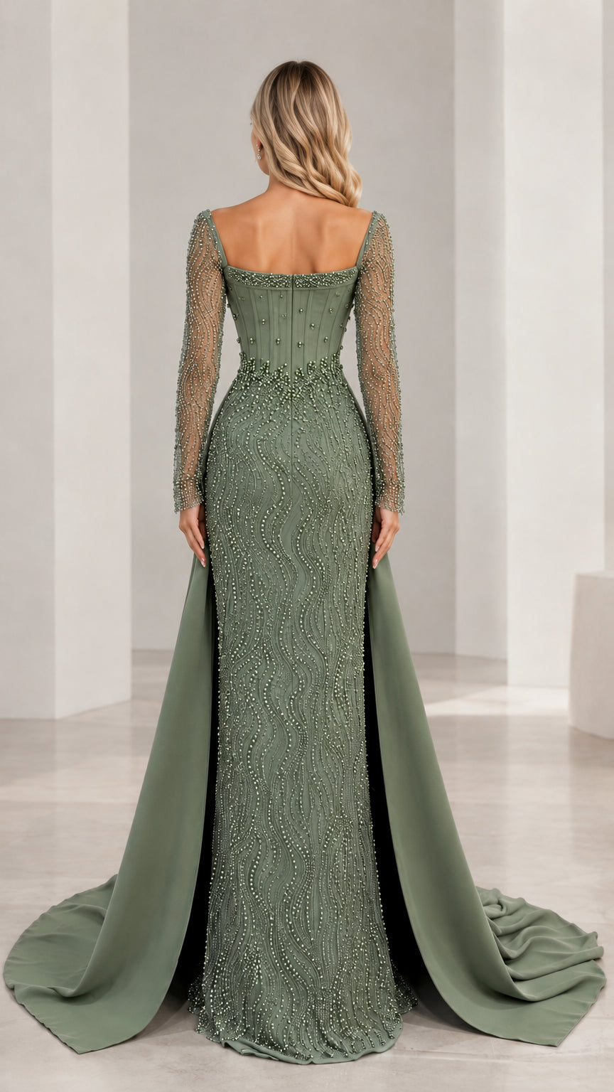 Back view of sage green formal gown featuring structured bodice and flowing overskirt
