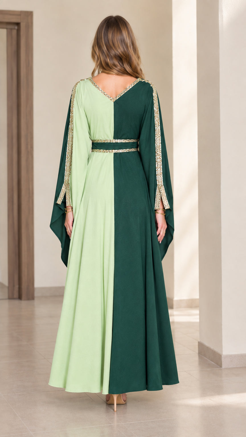Back view of two-tone green flowing maxi caftan gown with gold accents