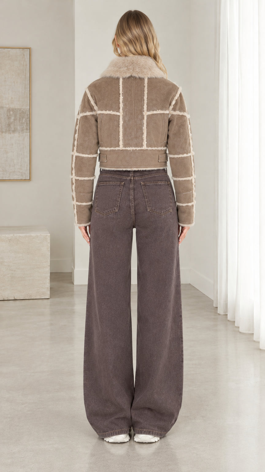 Back view of taupe cropped faux suede shearling jacket showing geometric paneling